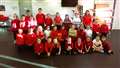 Pupils present wristbands and iced biscuits for Children in Need.
