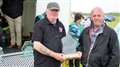 Winner of the best exhibit for the Edward Sutherland Memorial Trophy was a 1970 Morris light van owned by Alan Ross from Wick. Alan’s nephew, of the same name, accepts the award from Kevin Sutherland. Picture: DGS