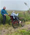 George gives one of the Dunbeath group a chance to try the Paratreker on the track at St John's Loch.