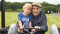 Peter Stewart from Thrumster, right, sits on a vintage tractor with his grandson Camden Hollick.