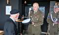 Polish defence attaché Colonel Mieczysław Malec hands Richard the honorary naval hat.