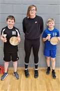 U13 boys' doubles winners Angus Mackay and Rory Nicolson with Chloe Mackenzie from sponsor Highland Workwear.