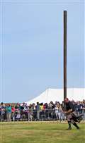 Another athlete, Stewart Anderson, takes part in the caber toss. Picture: DGS
