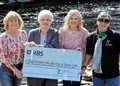 Musician Catherine MacKenzie hands out charity cheques