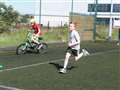 Running and cycling side by side in the junior triathlon at Wick.