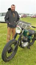 Michael Cragg beside a BSA motorbike he helped restore. Picture: DGS