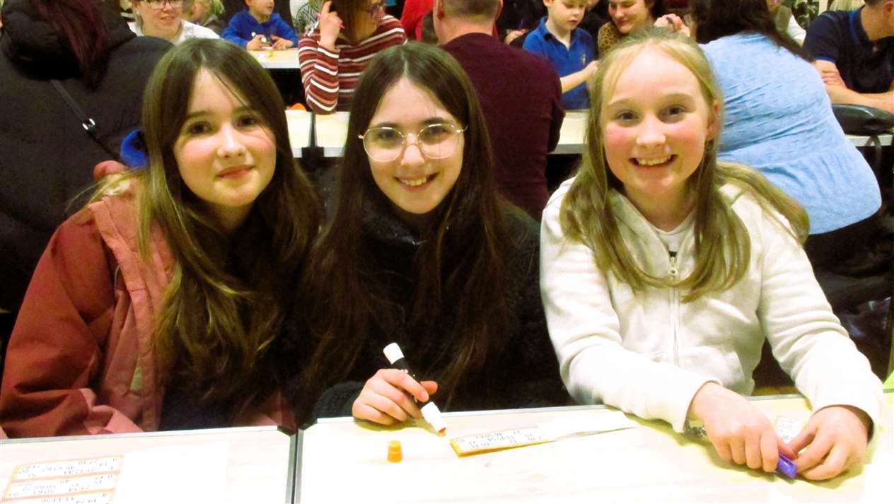 Three pupils get ready to dab.
