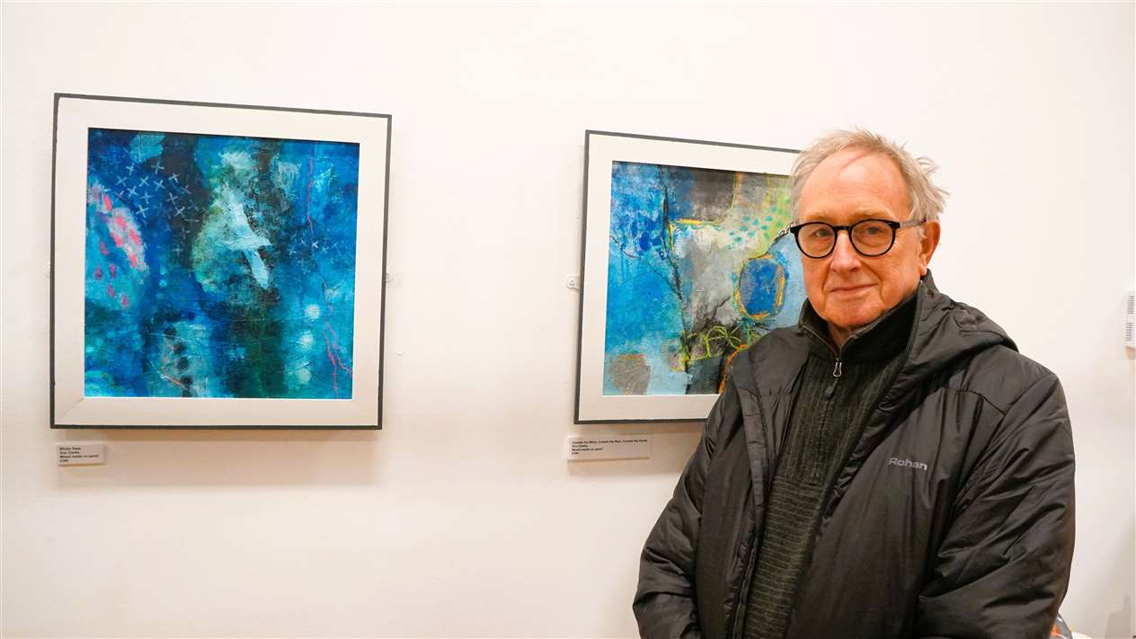 Don Clarke with his mixed media on panel works at the Winter exhibition in Thurso. Picture: DGS