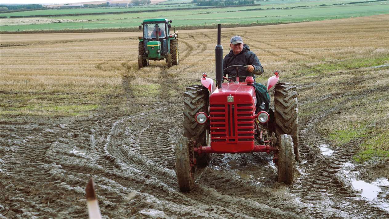 Leaving the field are Jonnie Mathieson on the red tractor at front followed by Robbie Flett on his John Deere. Picture: DGS