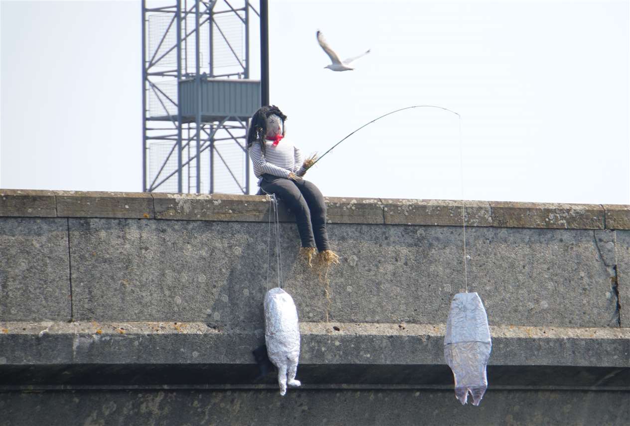 A passing gull shows no interest in the fisherman's catch for some odd reason. One of Wick's scarecrows during the gala week.