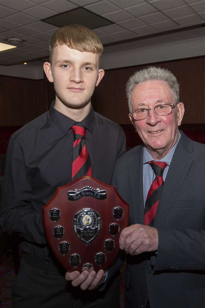 Wick Groats' young player of the year, Mark Macadie, accepting his trophy from Jocky Shearer.
