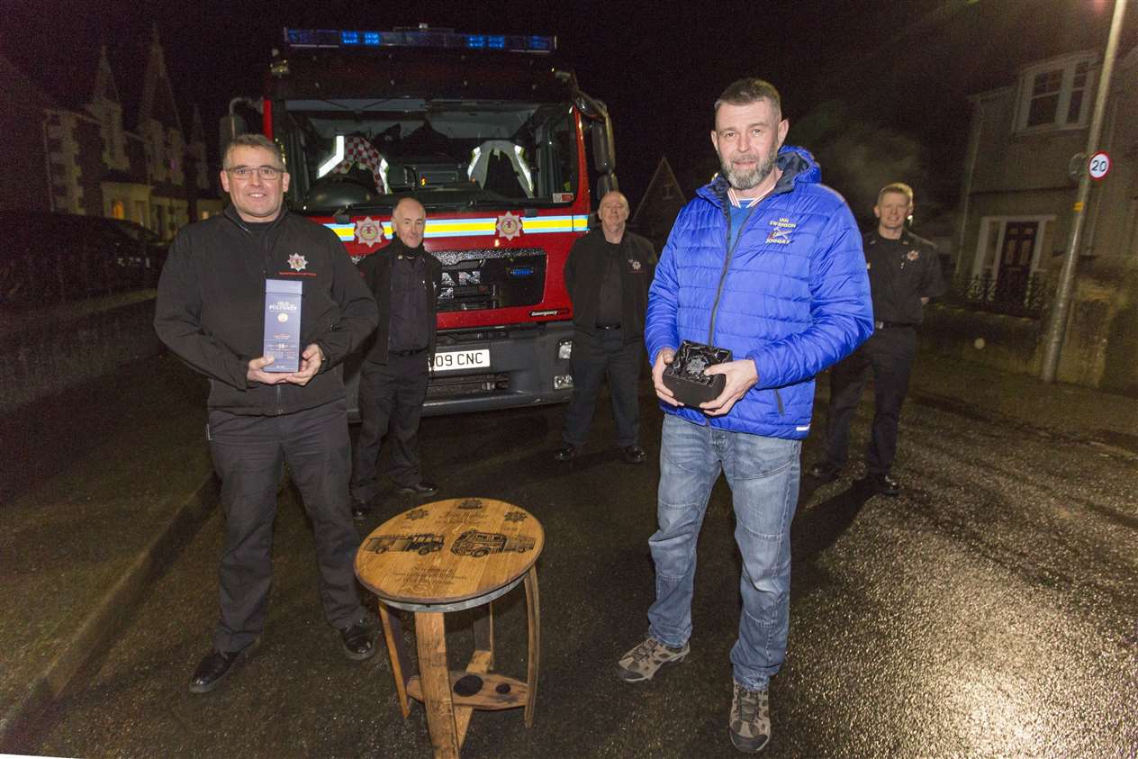 Ian Swanson (front right) was presented with the gifts outside his home in Newton Avenue, where watch commander Colin Gunn (left) handed them over with crew commanders Hugo Ross, Richard Mackay and Graeme Miller. Picture: Robert MacDonald/Northern Studios