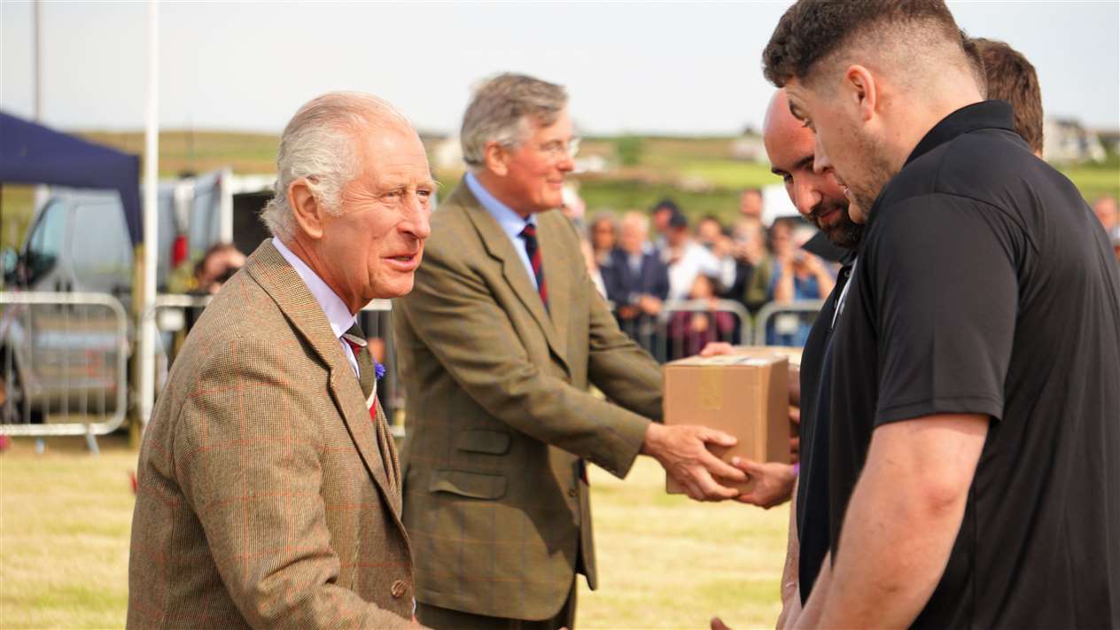 King Charles III congratulates Caithness Rugby Club which won the tug of war. Picture: DGS