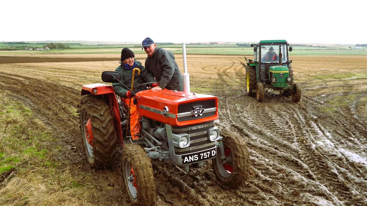 Don Macleod driving and Clair Meiklejohn standing on a Massey Ferguson tractor. Picture: DGS
