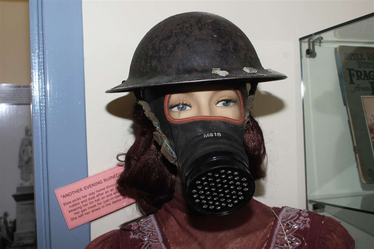 A model with a World War II gas mask.