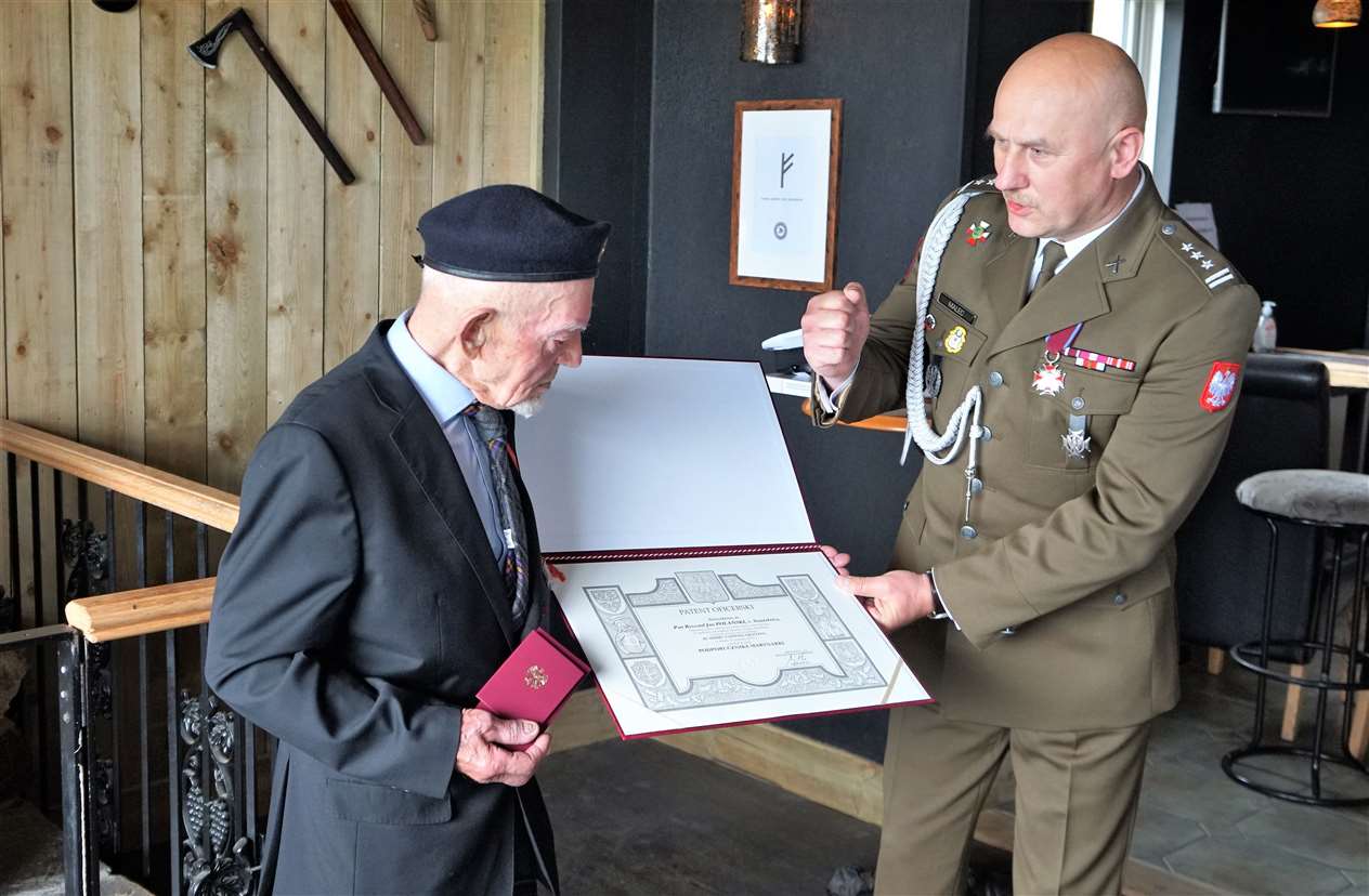 Col Malec gives the veteran another special award on behalf of the Polish president.
