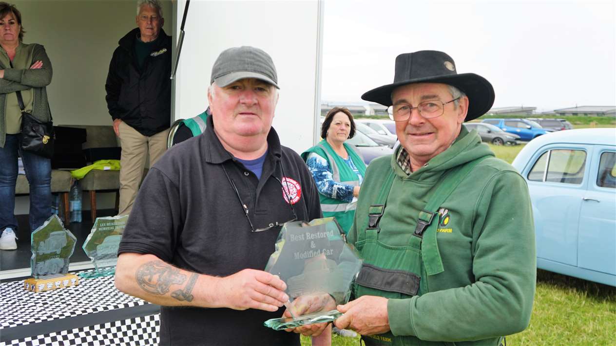 Receiving the Tom Sayles Trophy for best restored or modified vehicle from Kevin Sutherland, left, was George Williamson from Scarfskerry with a 1973 Bedford TK lorry. Picture: DGS
