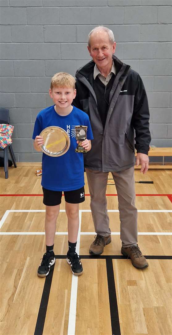 Under-11 boys' singles winner Liam Sinclair with tournament sponsor Ronald Mackay.