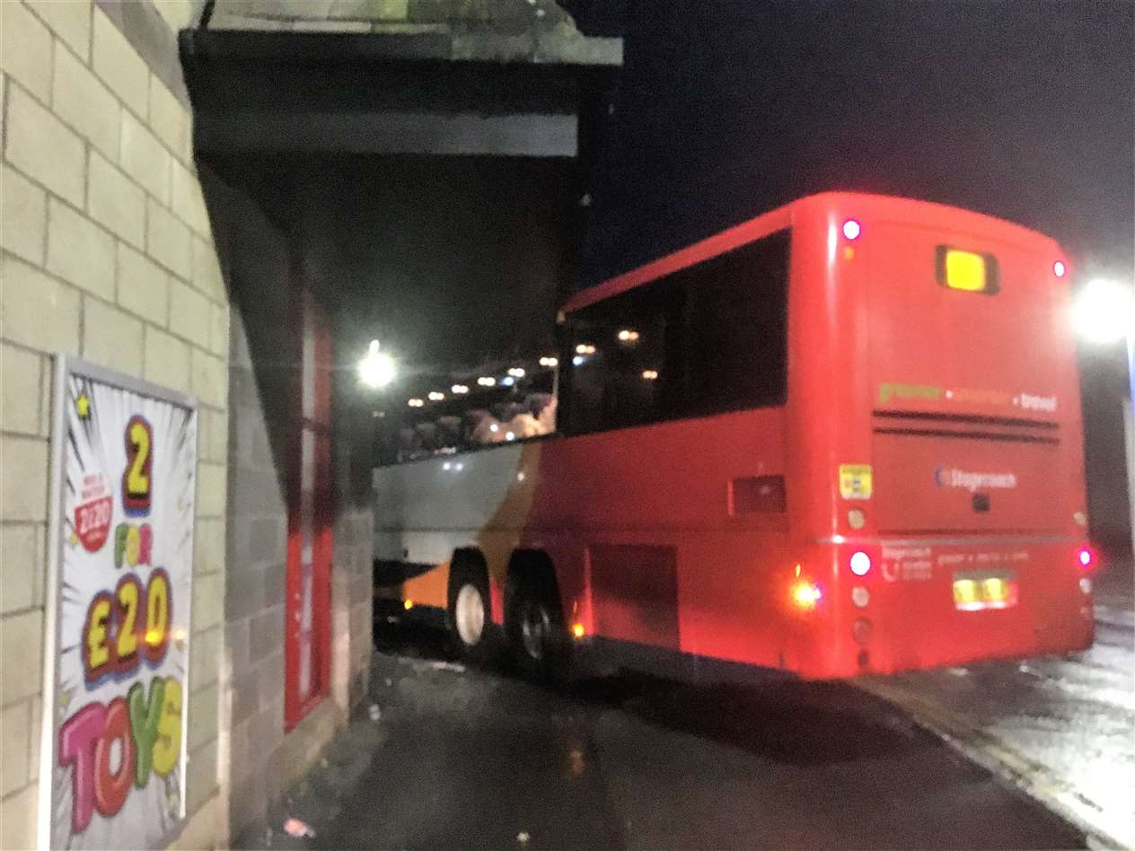 The X99 bus just after the crash in Wick. It was reported to have skidded down the entire length of Whitechapel Road before hitting the store on St Fergus Road. Picture: Donald Dale