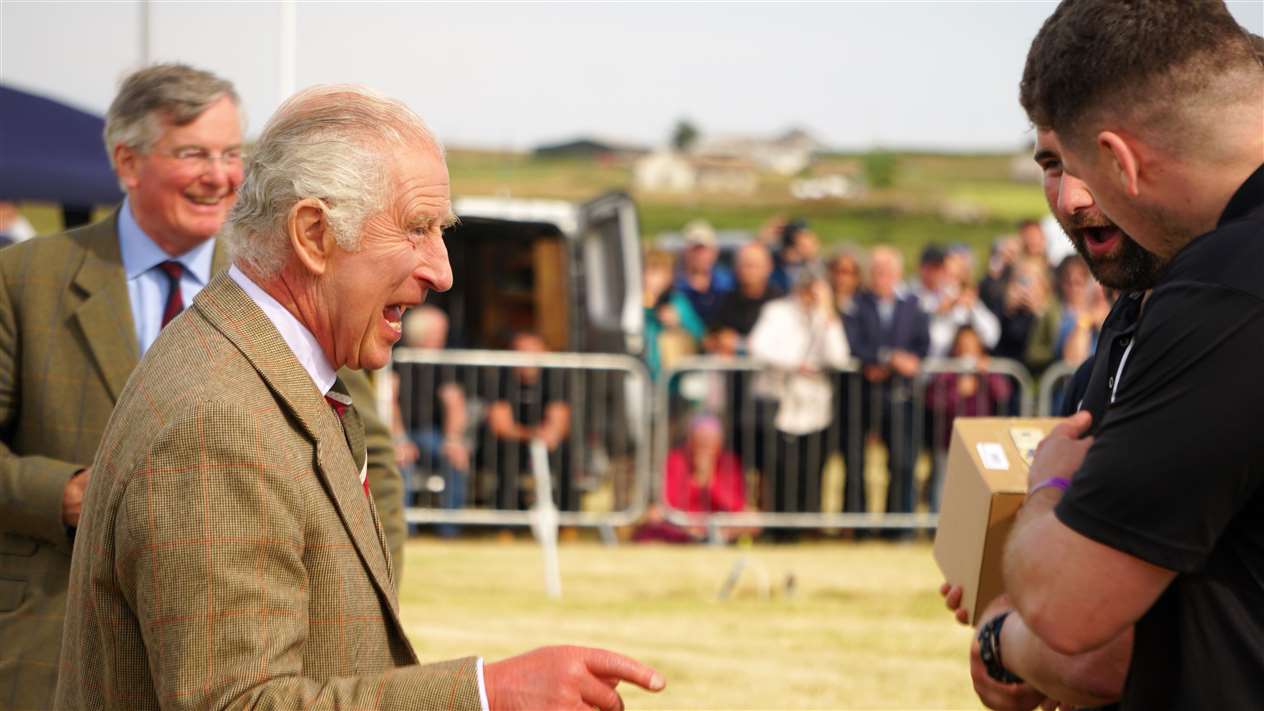 King Charles III congratulates Caithness Rugby Club which won the tug of war. Picture: DGS