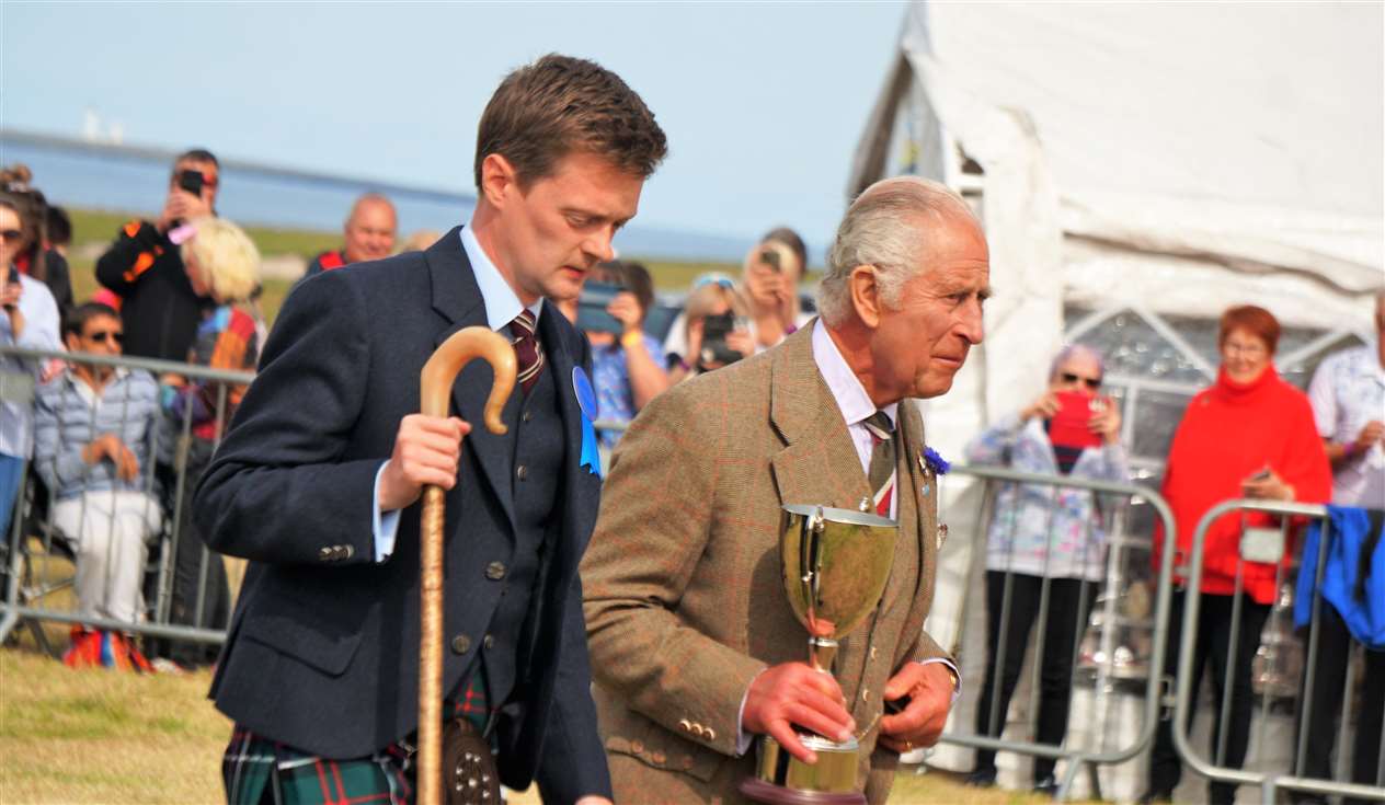 King Charles III presents a cup to the rugby club team which won the tug of war competition. Picture: DGS