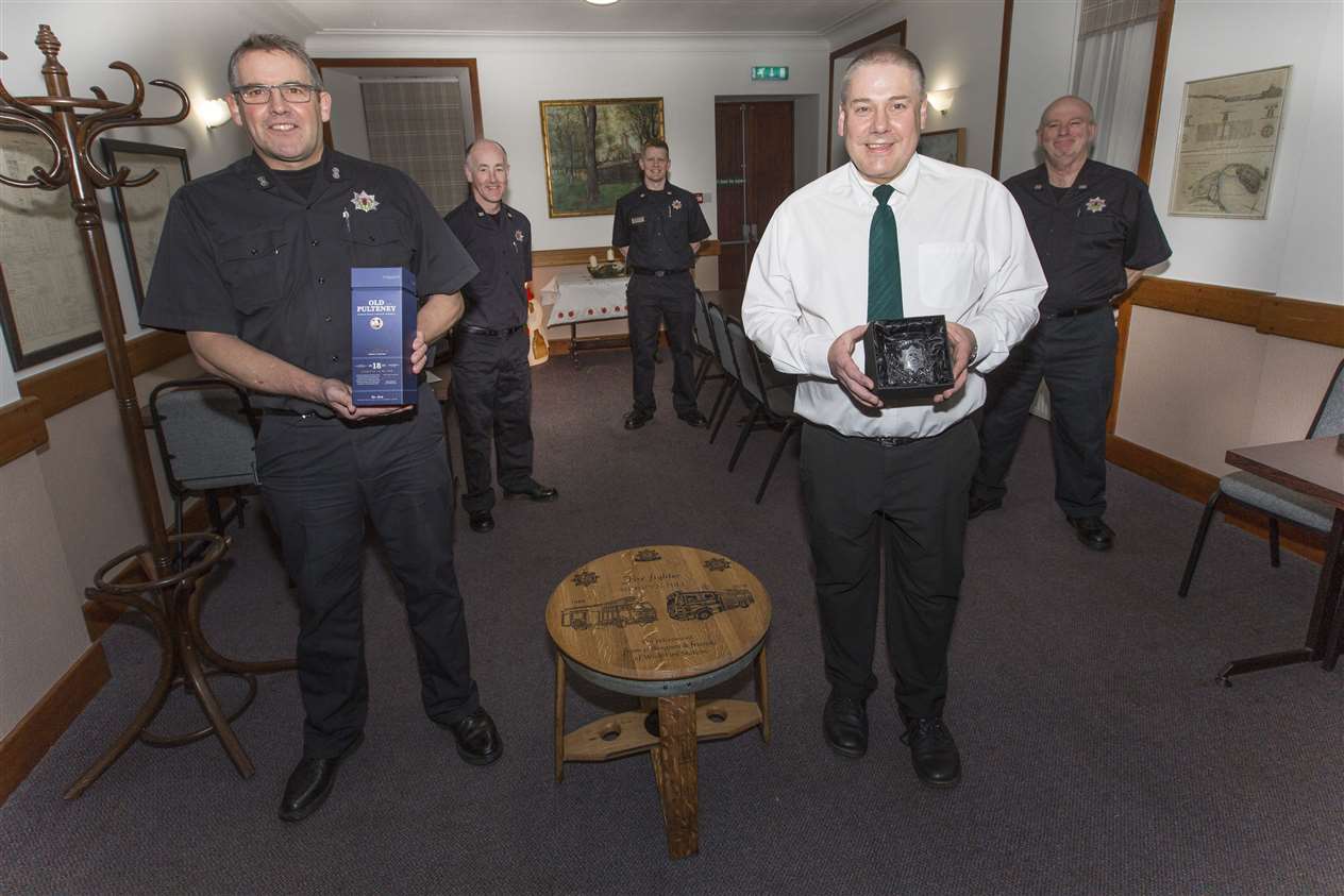 Watch commander Colin Gunn (left) handed over the gifts to Mervyn Hill (front right) from crew commanders Hugo Ross, Graeme Miller and Richard Mackay. Picture: Robert MacDonald/Northern Studios