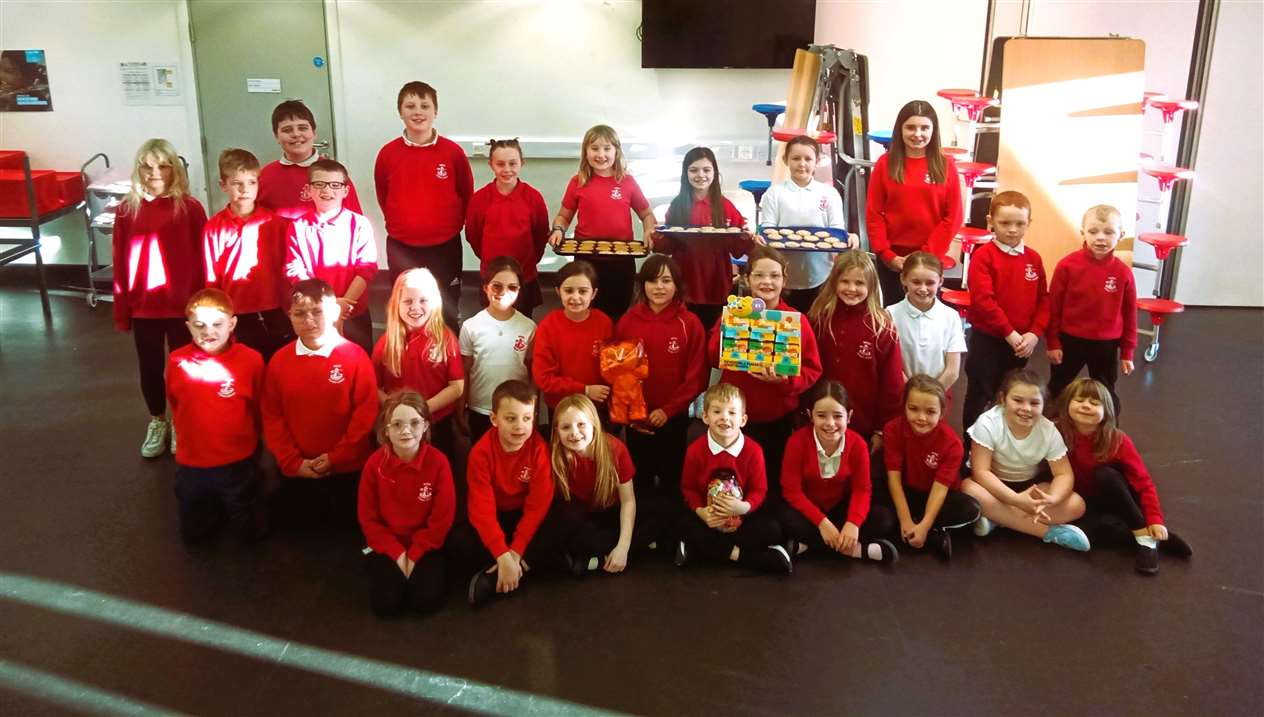 Pupils present wristbands and iced biscuits for Children in Need.