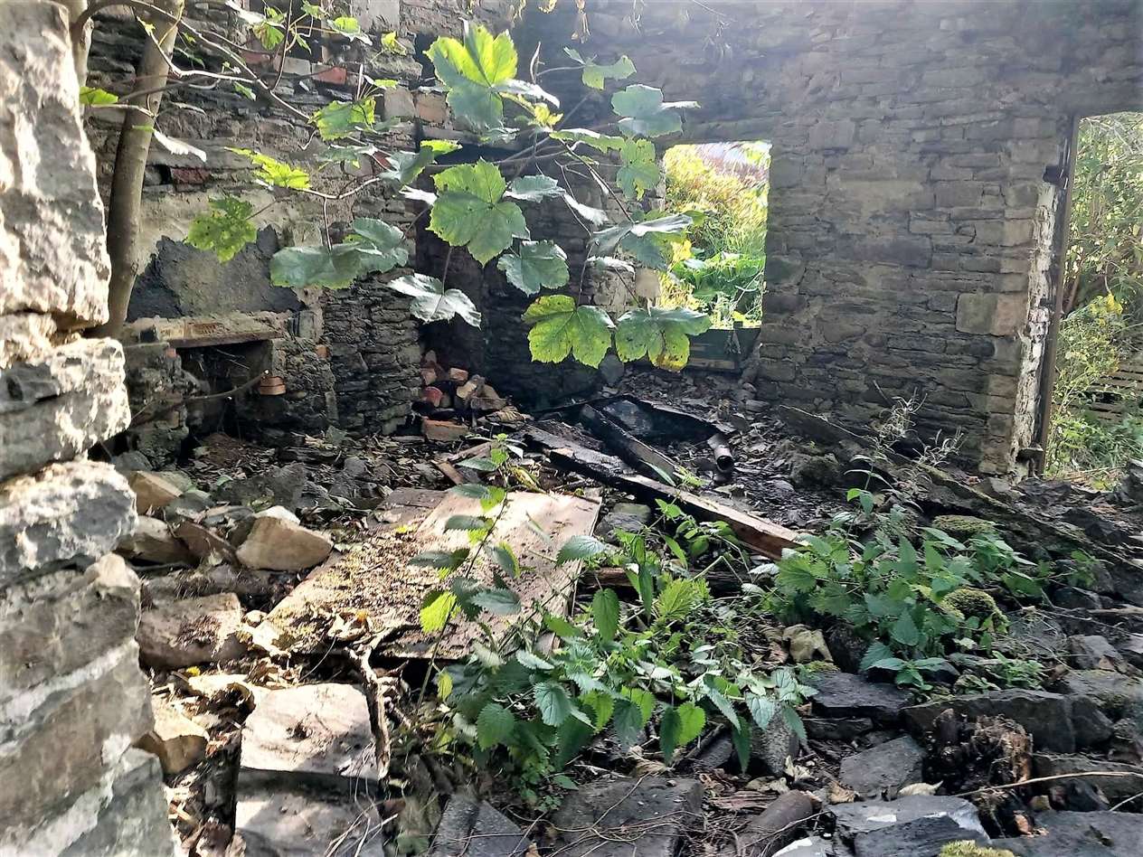 Charred wood inside the derelict cottage showing where the fire was. Picture supplied