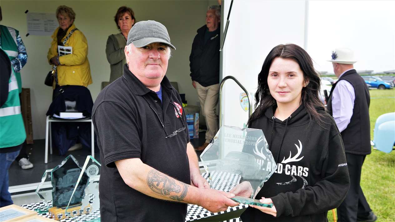 Seventeen-year-old Sophie Mackillop from Wick received the Lee Meiklejohn Memorial Trophy for Best Junior Car Enthusiast from club chair Kevin Sutherland. Picture: DGS