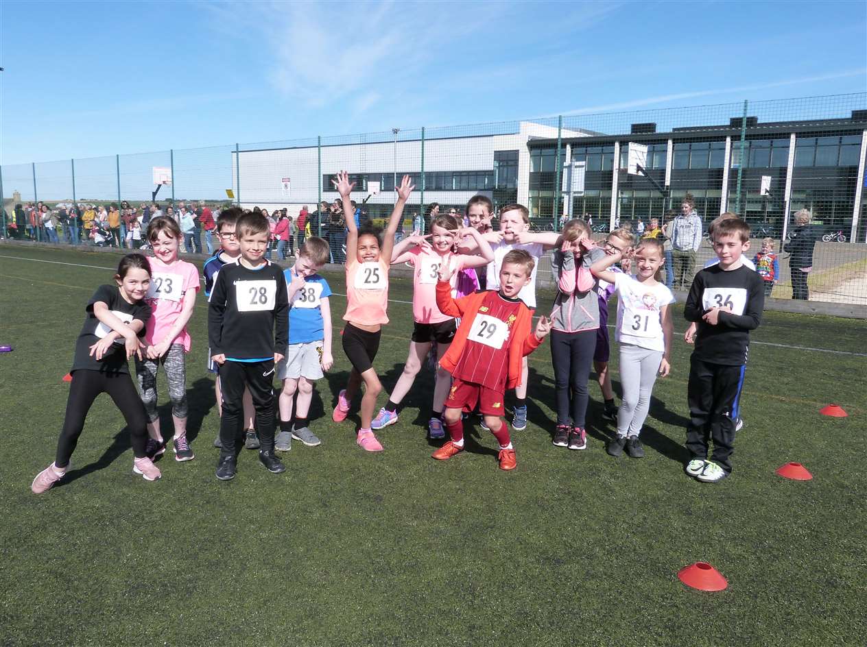 Junior triathletes in high spirits at the Wick all-weather pitch.