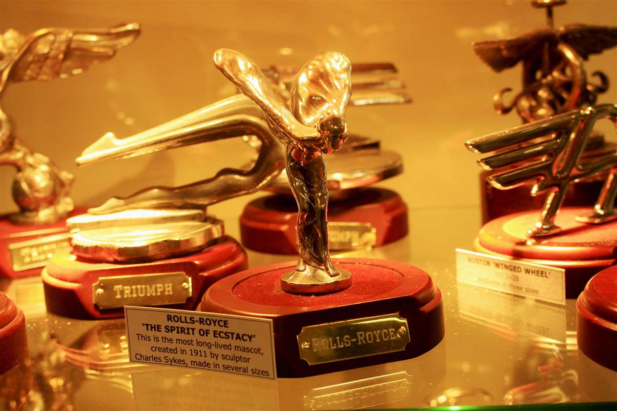 Car mascots in one of the display cabinets.