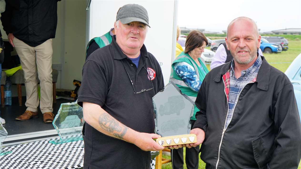 Winner of the best exhibit for the Edward Sutherland Memorial Trophy was a 1970 Morris light van owned by Alan Ross from Wick. Alan’s nephew, of the same name, accepts the award from Kevin Sutherland. Picture: DGS