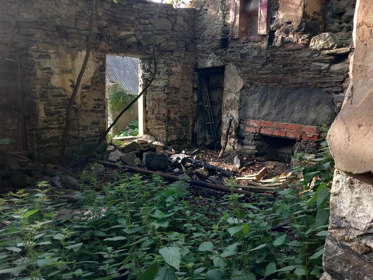 Charred wood inside the derelict cottage showing where the fire was. Picture supplied