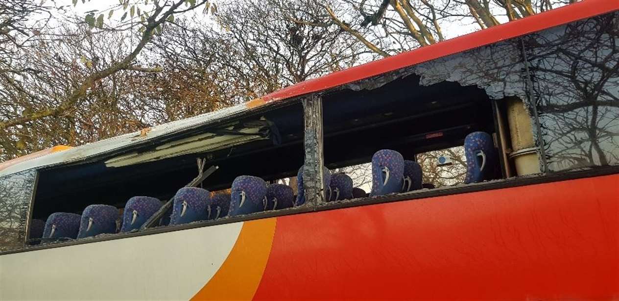 Smashed windows on the bus bear testament to the force of the smash.