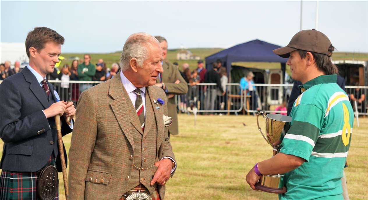 King Charles III congratulates Caithness Rugby Club which won the tug of war. Picture: DGS