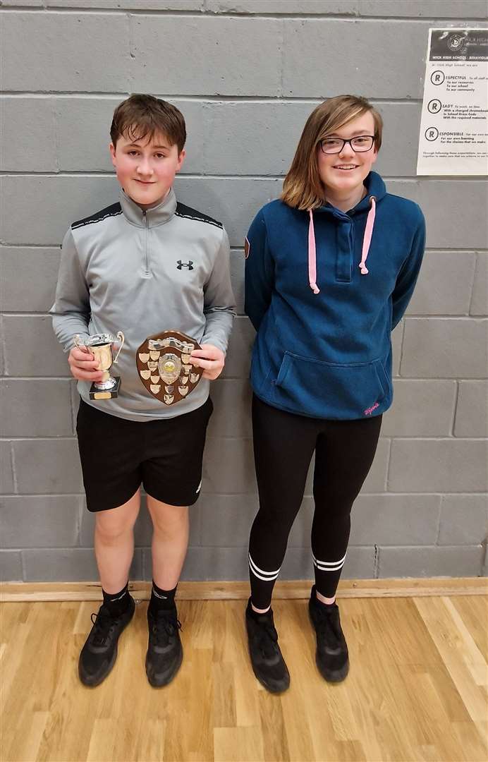 Boys' singles winner Lewis Malcolm with Chloe Mackenzie of Highland Workwear.