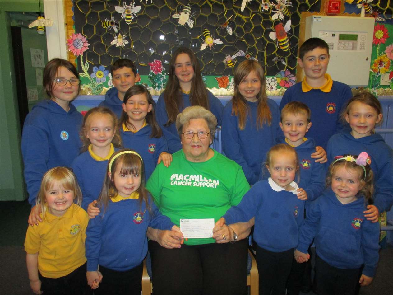 Sheila Sinclair, secretary of the Thurso fundraising committee with a child from each of our classes, with our cheque for all of the money raised, £2436.19.