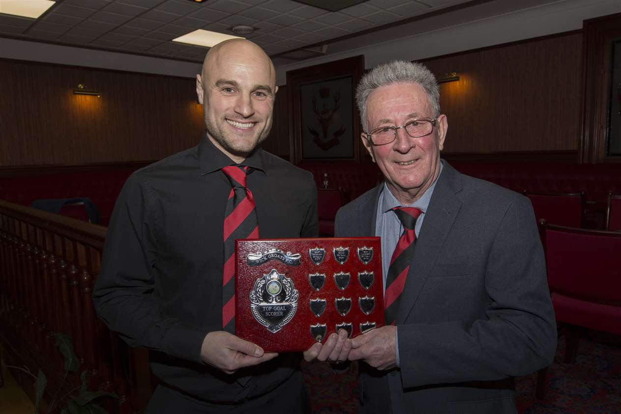 Wick Groats' top scorer Sandy Sutherland receives his trophy from long-time supporter and club stalwart Jocky Shearer.