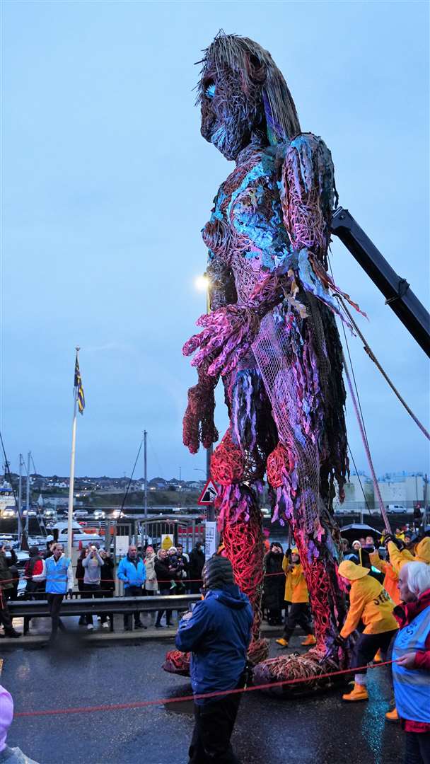 The 10-metre tall puppet walks by the harbour. Picture: DGS