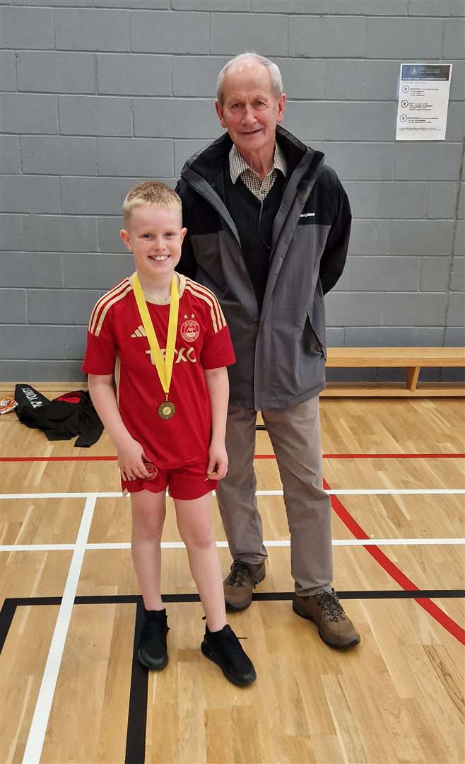 U11 boys' consolation winner Joshua Mackenzie with tournament sponsor Ronald Mackay.