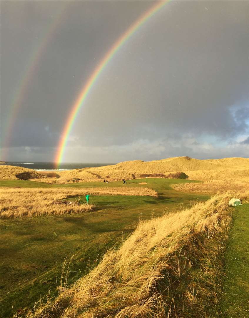 A recent view of the sixth hole at Reay golf course with a rainbow over the green.