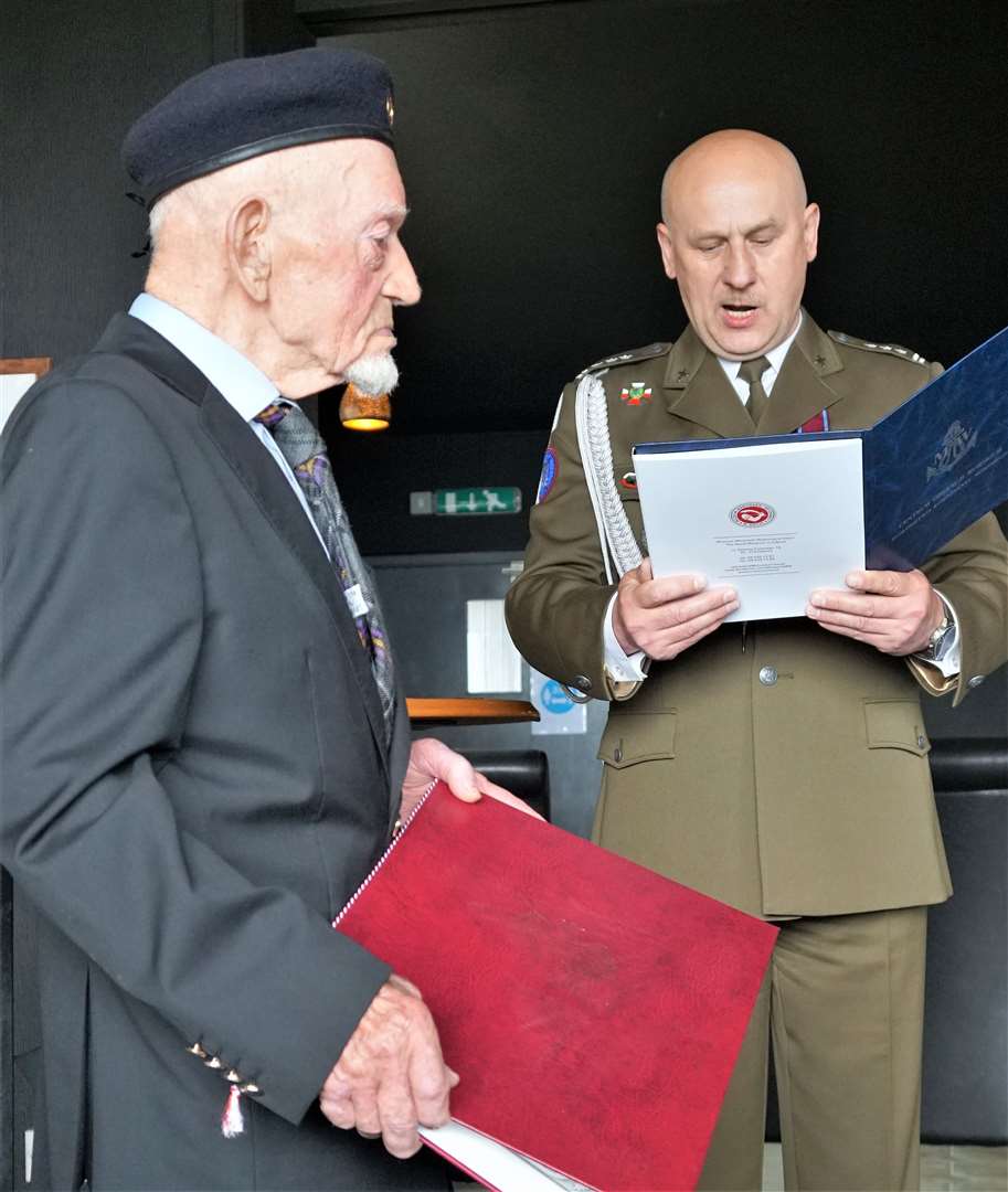 Colonel Malec from the Polish embassy tells the assembled audience that Richard is being honoured for his 'sacrifice for Polish and European freedom'.