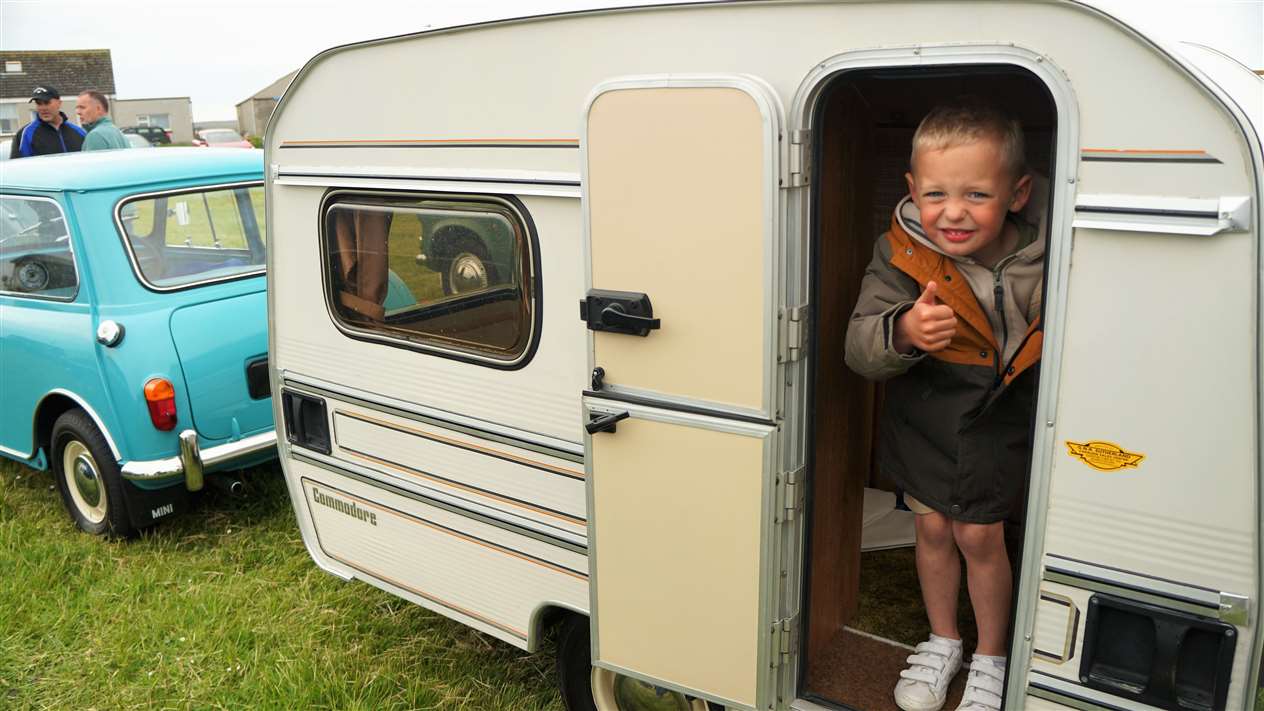 Young Mikey who was visiting the rally stands in a tiny caravan. Picture: DGS
