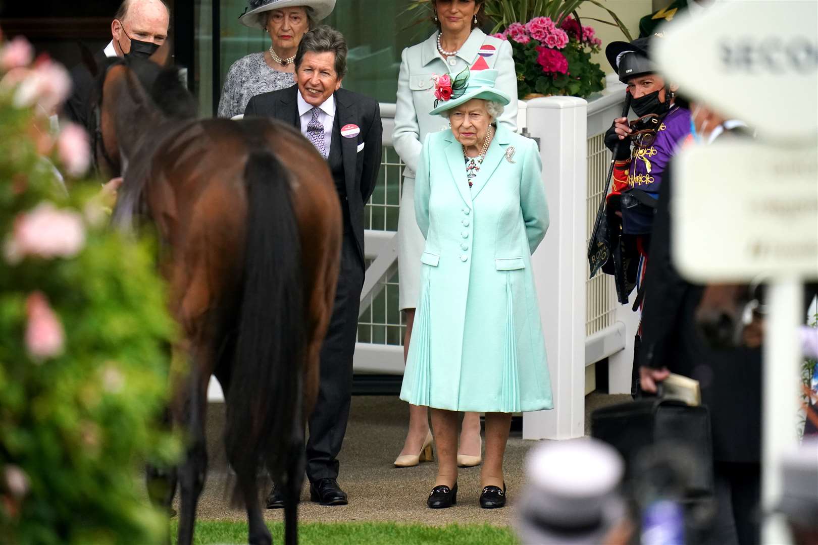 Queen Elizabeth with her racing manager John Warren and jockey Frankie Dettori inspect the monarch’s horse Reach For The Moon during Royal Ascot in 2021 (Andrew Matthews/PA)