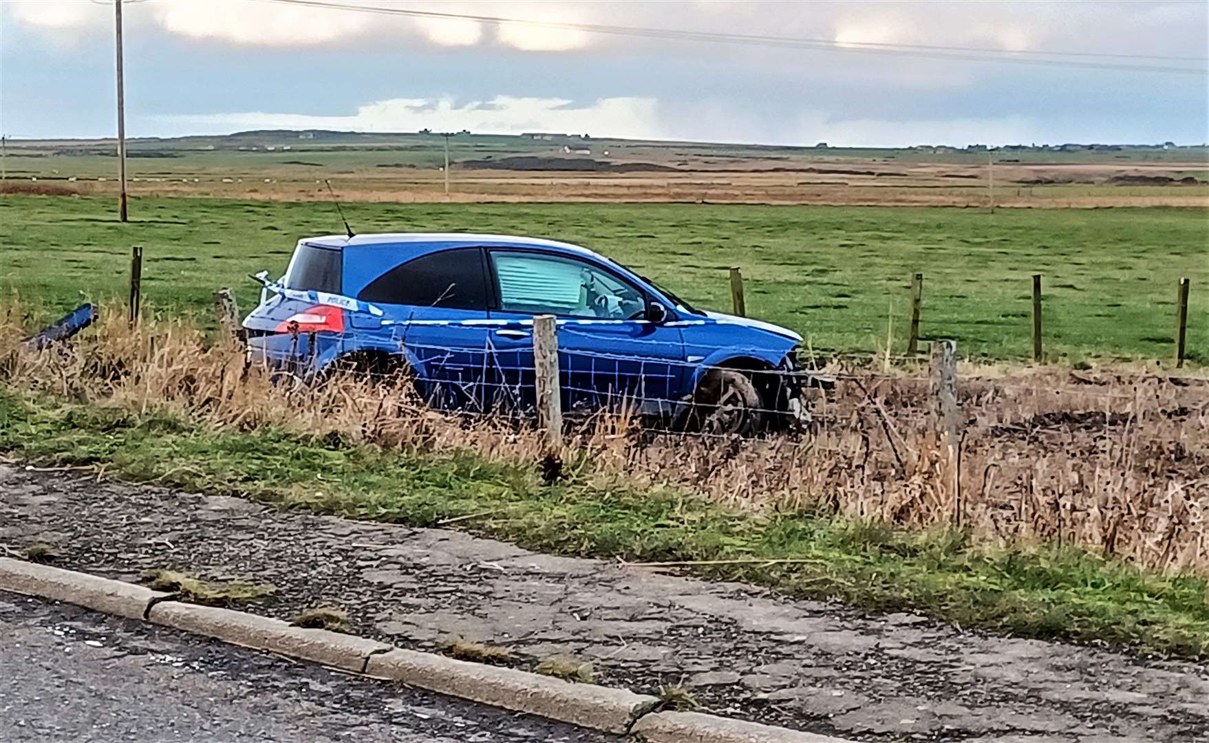 Car in a field by the A882 at Milton.