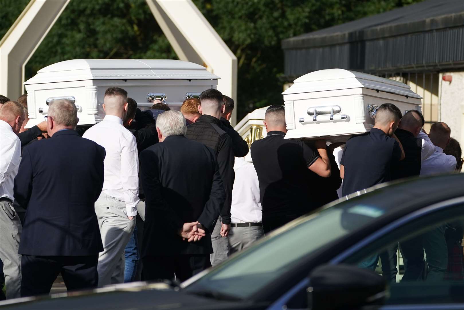 The coffins of Lisa Cash, 18, and her eight-year-old twin siblings, Christy and Chelsea Cawley, arrive at St Aidan’s Church, Brookfield, Tallaght (Brian Lawless/PA)