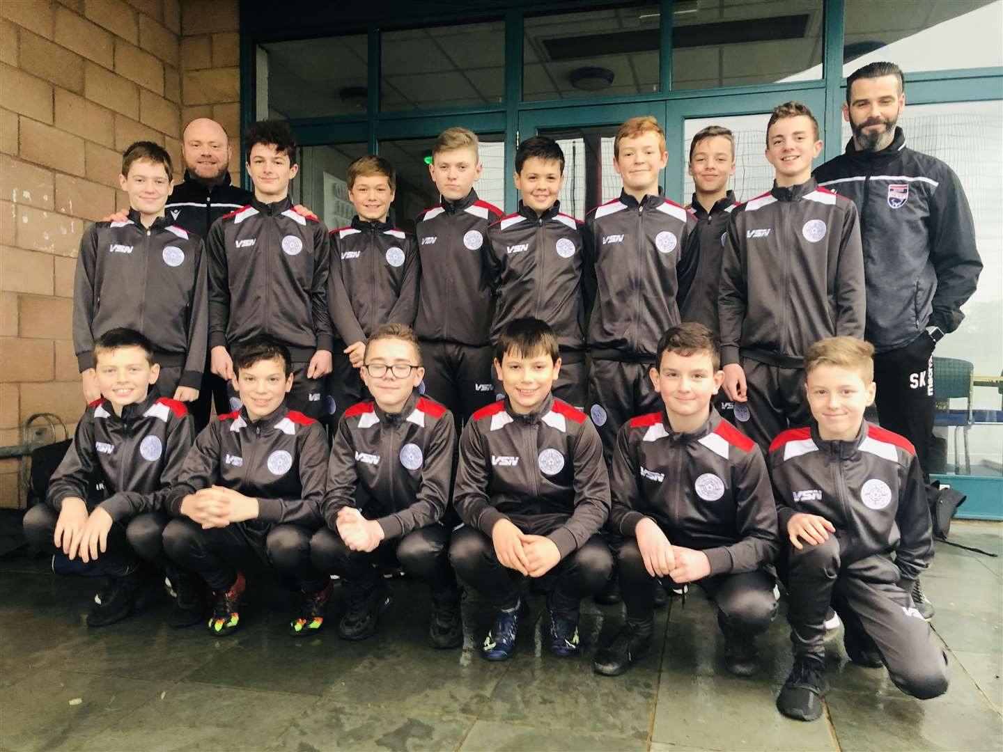 The Caithness United under-13s with Ross County co-managers Steven Ferguson and Stuart Kettlewell.