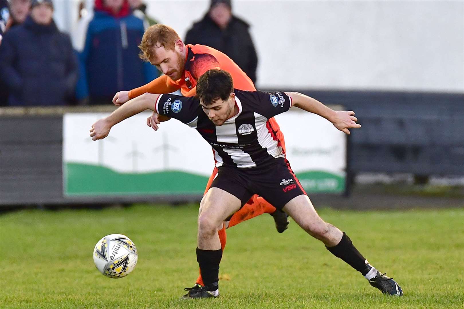 Wick Academy's Marc Coghill holds off a challenge from Greg Morrison of Rothes. Picture: Mel Roger