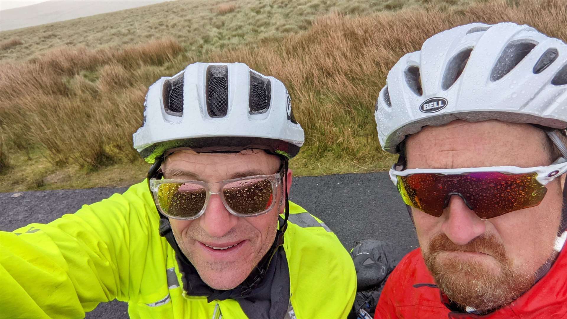 Charity cyclists James Graham (left) and Tom Shearman getting soaked in the Pennines two days before Tom had to pull out of the journey.