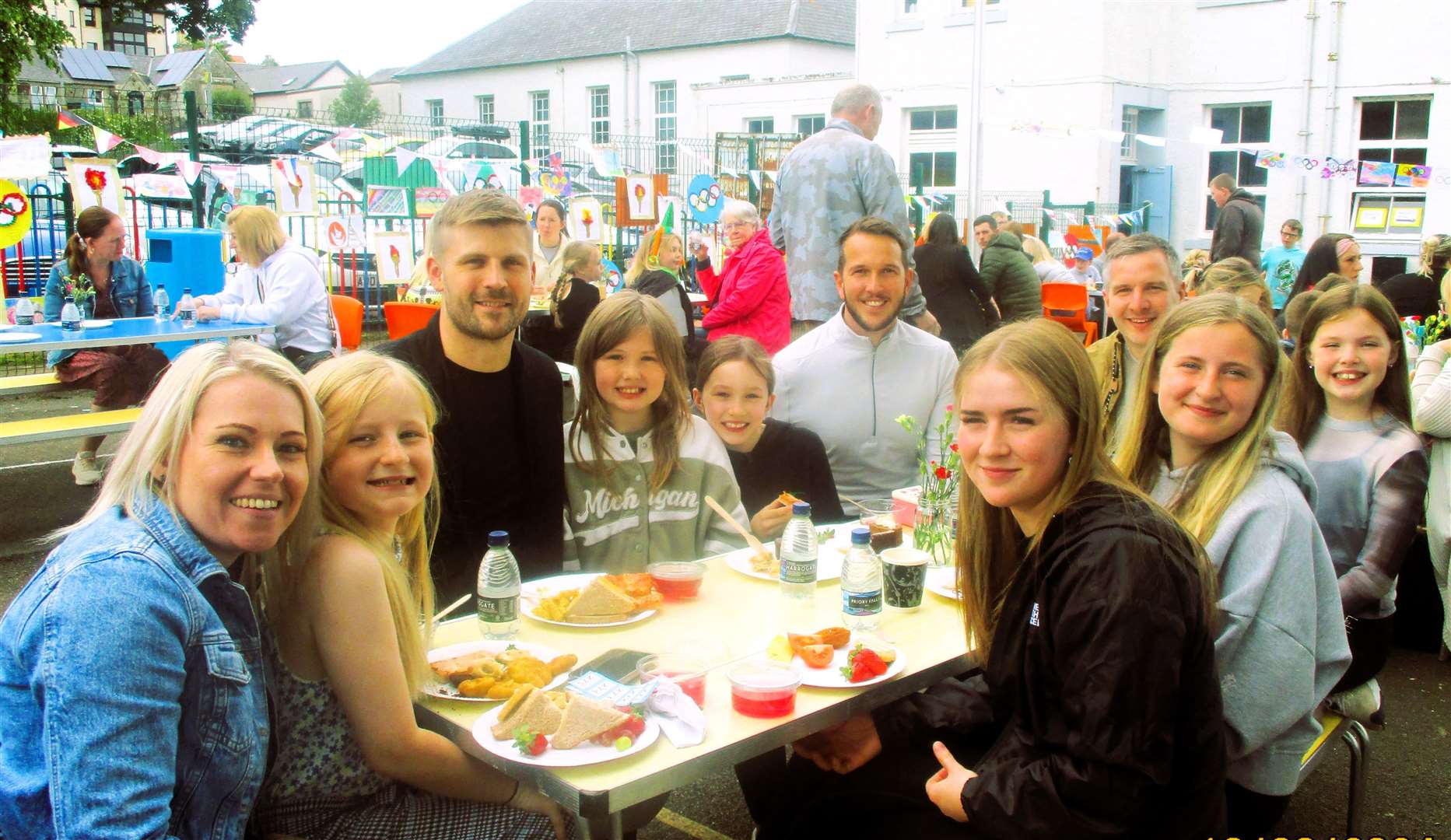 Families having fun over their picnic lunch. Pictures supplied